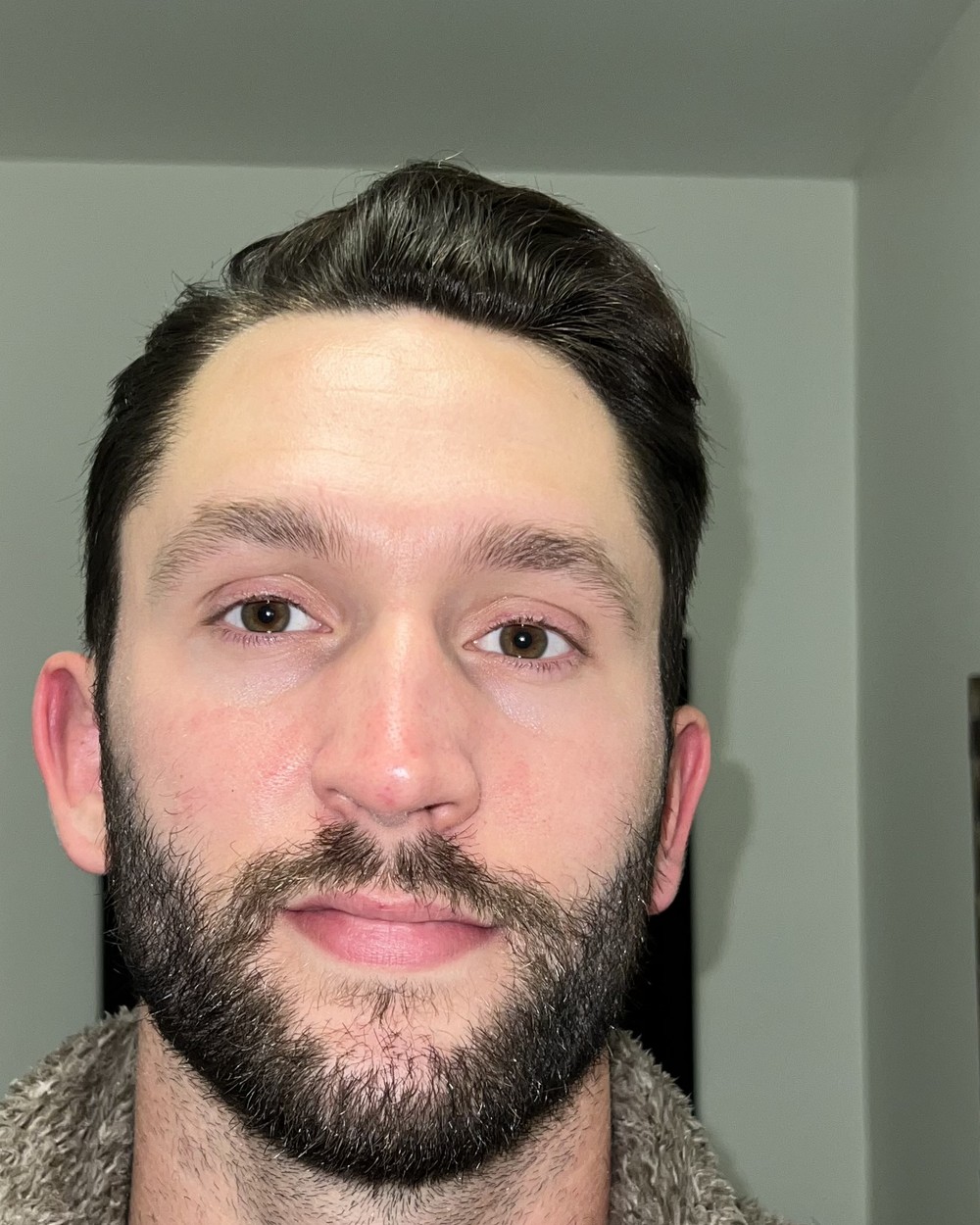Kevin on day 3 of using Revival, photographed in the same hallway at the same distance.